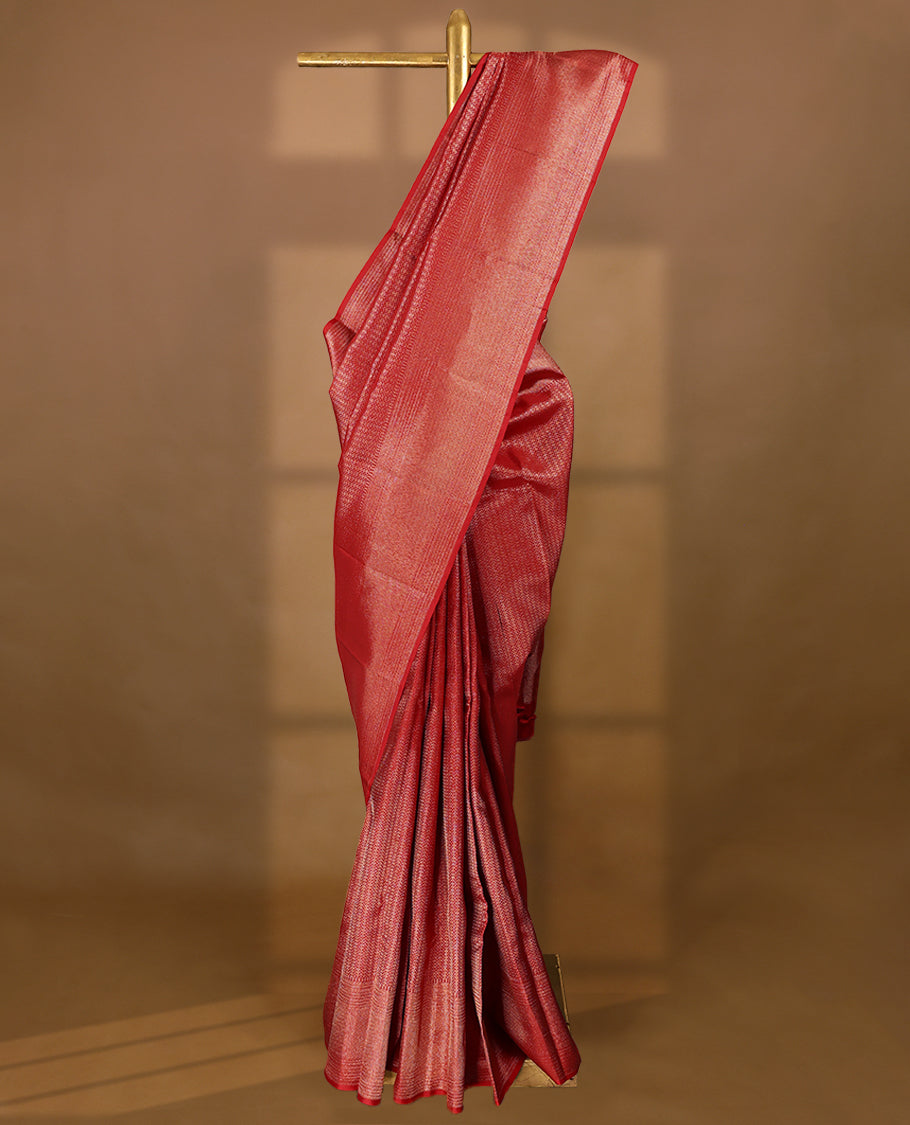 Red Colour Manthrakodi saree featuring a golden zari brocade body, complemented by a self coloured zigzag brocade border and a matching blouse.