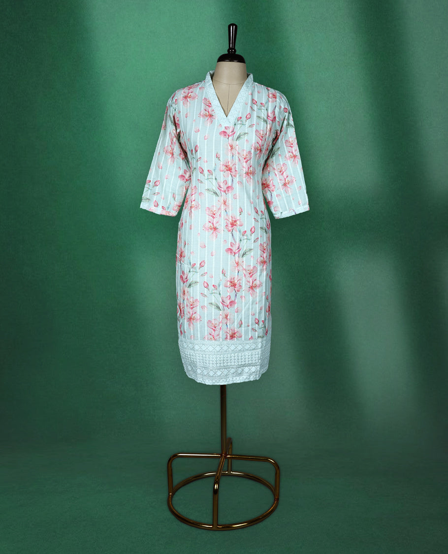 Mint green cotton kurti adorned with pink floral prints and white vertical stripes, featuring a V slit collared neckline, three quarter sleeves, and a white lace trimmed hem, fresh and feminine pick for everyday comfort.