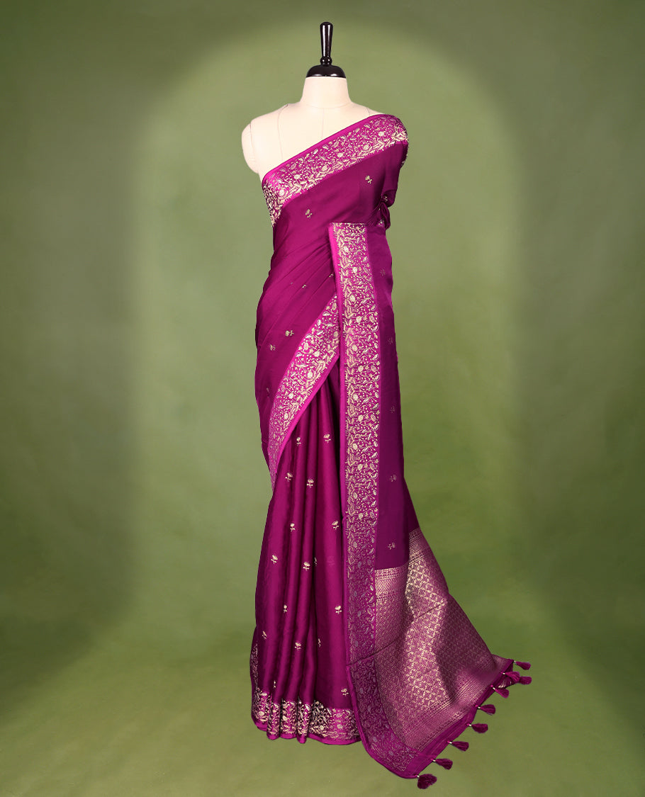 Grape colour pure Banaras crepe saree showcases elegant Gold zari Flower Motifs all over the body, a traditional gold & Silver zari border, a rich intricately woven pallu, and comes with a matching blouse.