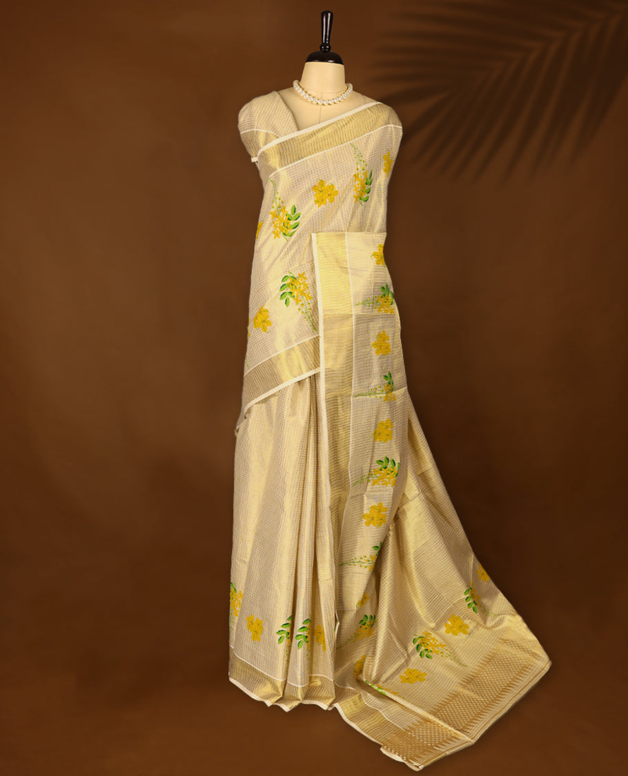 Kerala tissue saree with bright yellow floral motifs and a soft golden Border with Matching Blouse