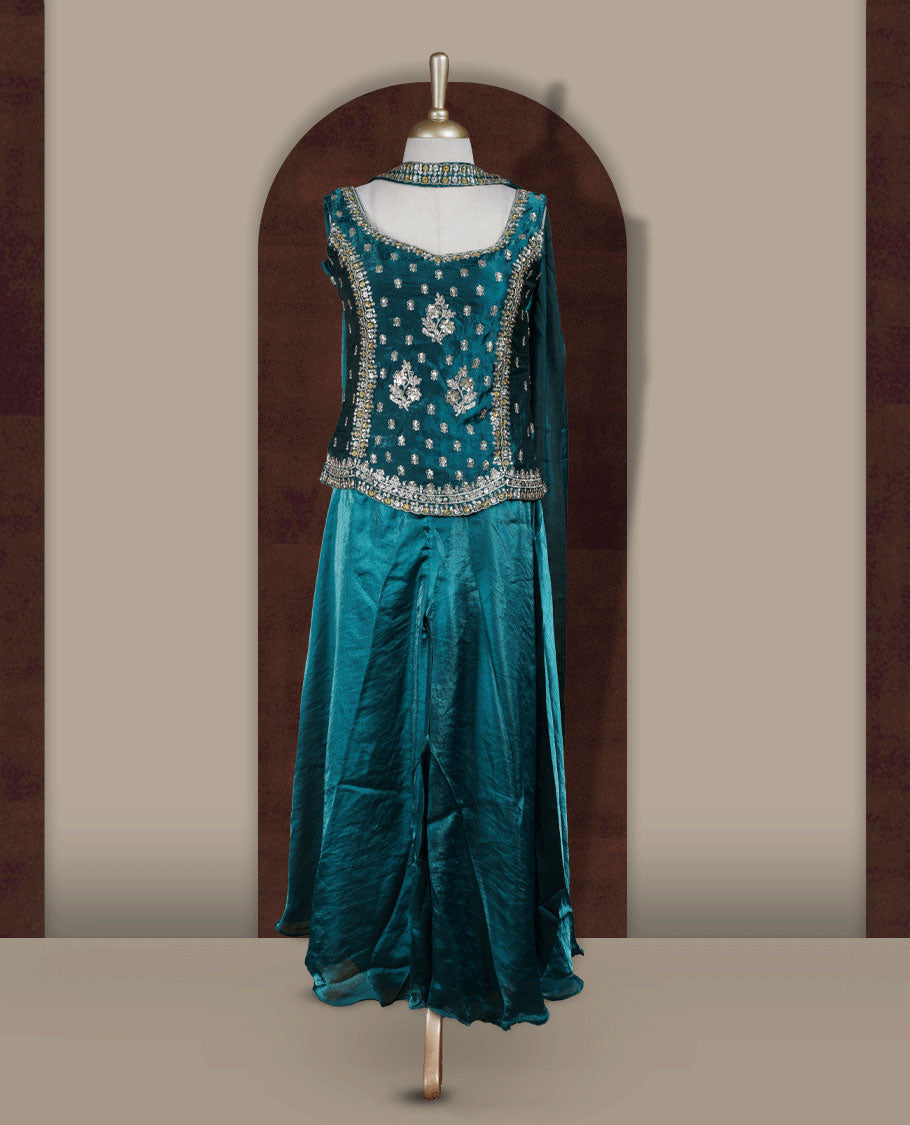 Rich peacock green colour sharara set adorned with intricate light golden embroidery and sequins work & The fitted embellished top pairs beautifully with the flared bottoms and matching dupatta.