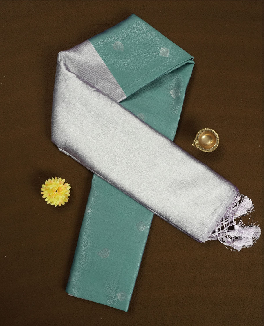 Sea Green colour Semi Silk Saree with Subtle Zari Butta Motifs on the Body, Contrasting Silver Zari Woven Pallu and Border with Intricate Patterns and Tassels, Paired with Coordinated Blouse Piece