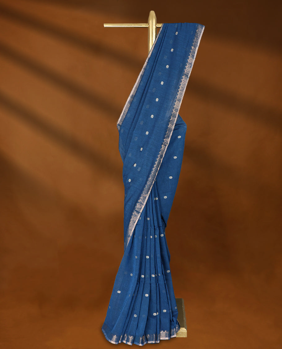 Blue colour soft khadi cotton saree with small Beige Zari Flower motifs on the body, detailed woven Gold zari border, paired pallu with tussles, with matching blouse.