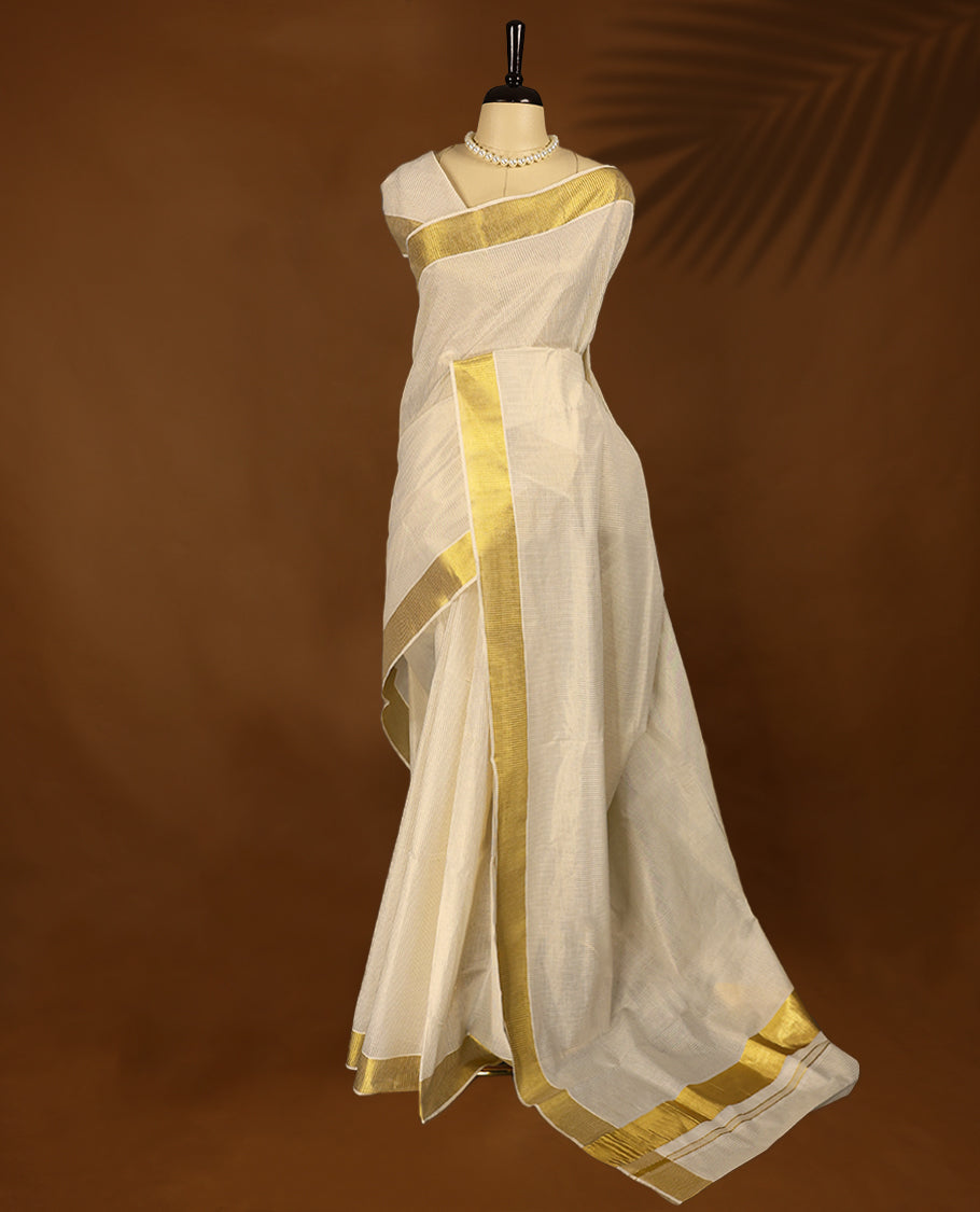 Kerala saree exudes timeless grace with its ivory base and rich golden zari border with Matching Blouse.