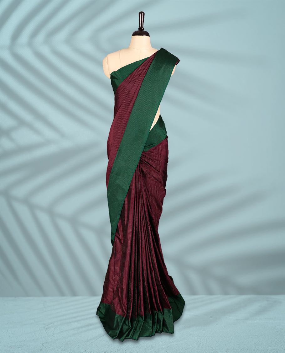 Deep Grape Colour semi silk saree features an elegant copper zari check pattern, complemented by a forest green border and a matching blouse
