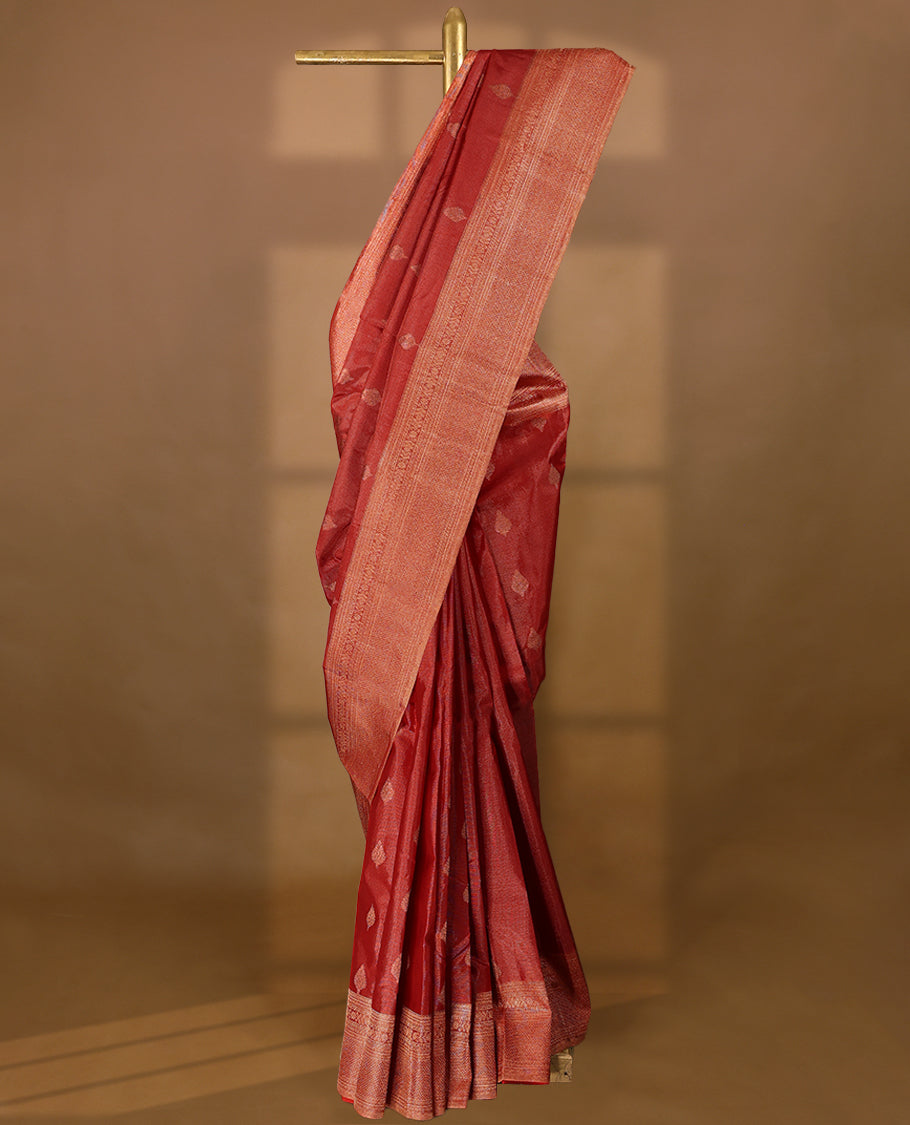 Red Colour Manthrakodi saree featuring tissue weaving with traditional motifs on the body, complemented by a self coloured traditional border and a matching self coloured blouse.