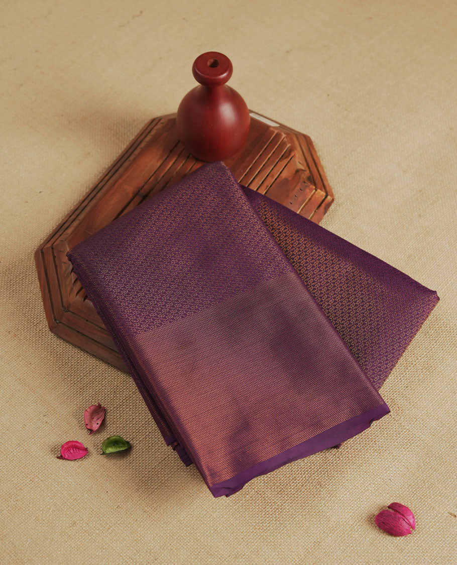 Deep purple colour semi silk saree featuring neem zari Brocade Pattern all over the body, complemented by a Self Colour woven border with detailing with contrast green Colour Pallu & blouse.