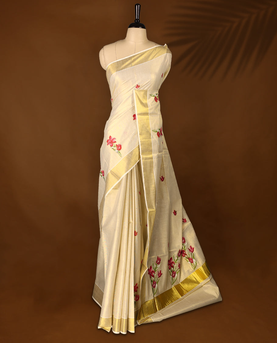 Light Gold colour Tissue Kerala saree featuring Flower Embroidery body and a beautifully woven Gold Kasavu border with Red & Pink colour Floral embroidery work, paired with a matching blouse perfect for festive occasions.