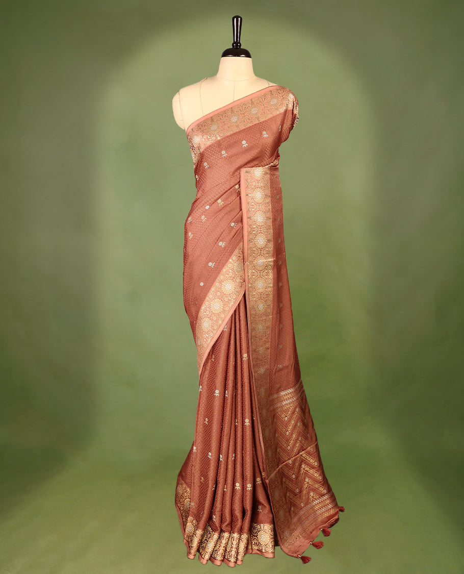 Pastel Brown colour pure Banaras crepe saree showcases elegant silver zari Flower Motifs all over the body, a traditional Banarasi gold zari border, a rich intricately woven pallu, and comes with a matching blouse.