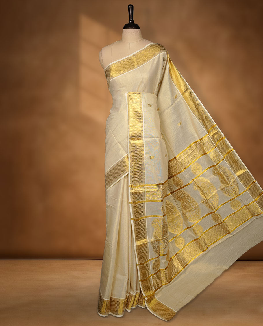 Light gold tissue Kerala saree featuring a softly shimmering body with delicate gold zari buttas, a refined kasavu border, and an intricately woven traditional pallu, paired with a matching blouse.