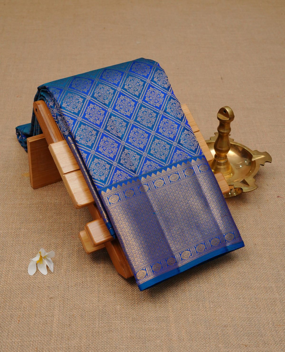 Blue colour Pure wedding silk saree featuring gold zari Check with designed pattern on body, complemented by self colour with traditional border, comes with a matching blouse piece.