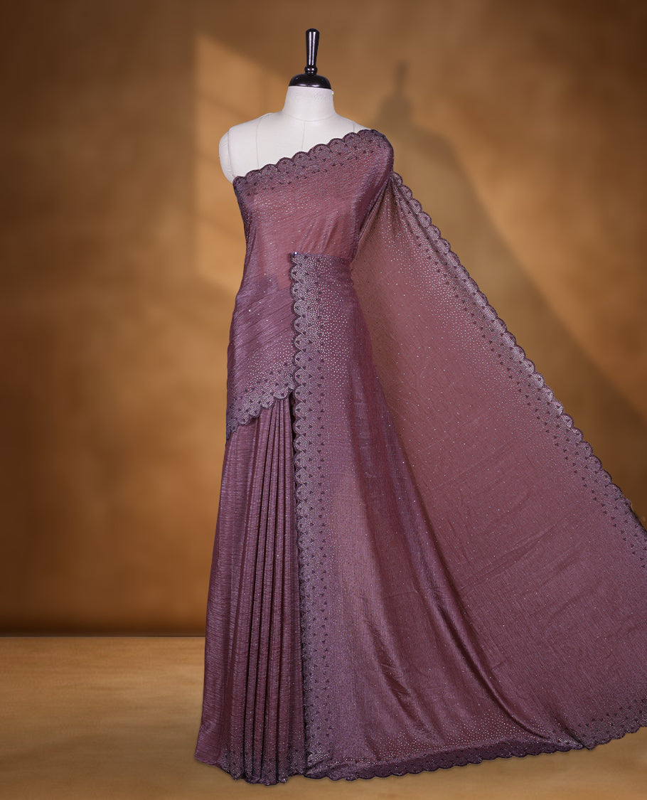 Grape colour chiffon designer saree, featuring black and white scattered stone on body, stone work and heavy stone pattern on border and pallu, Paired with matching blouse.