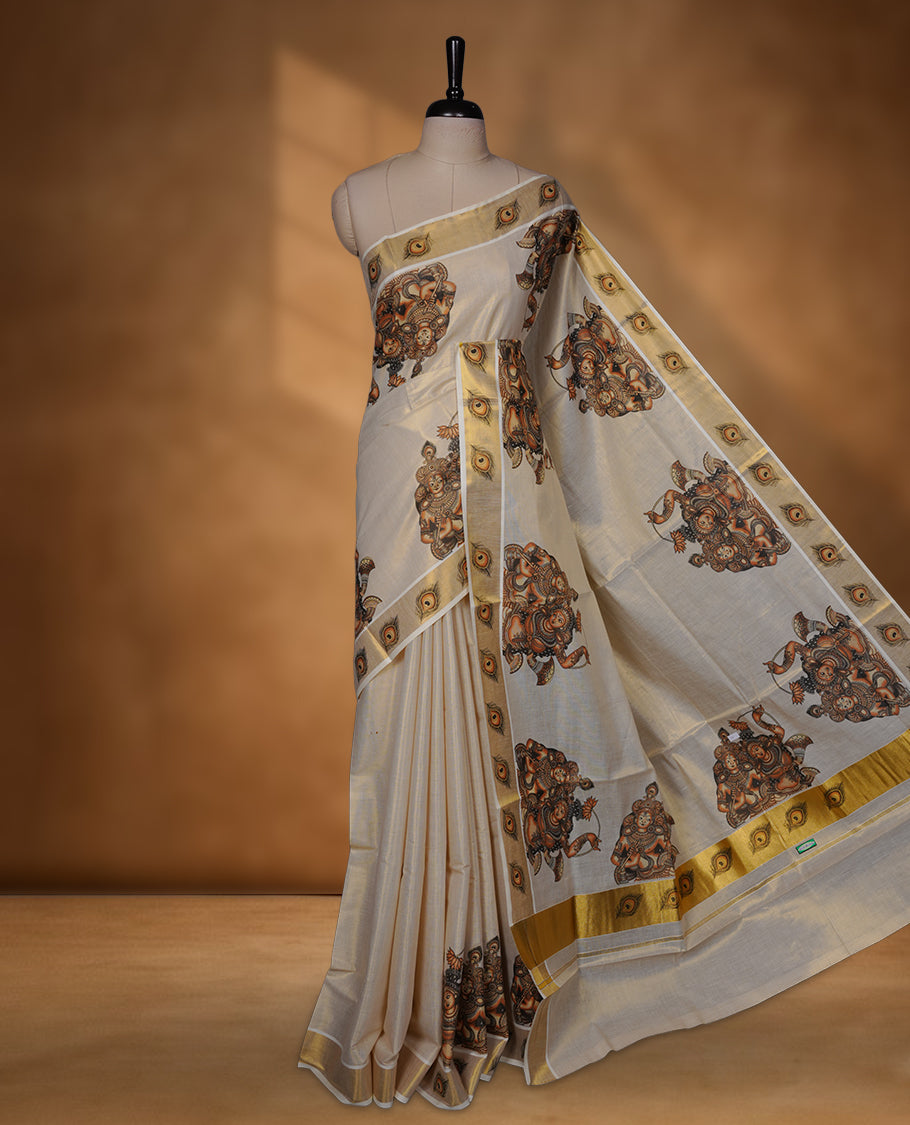 Off-white colour with gold tissue Kerala saree featuring traditional mural-inspired prints, peacock-feather border detailing, and a classic gold kasavu pallu. Includes matching blouse piece.