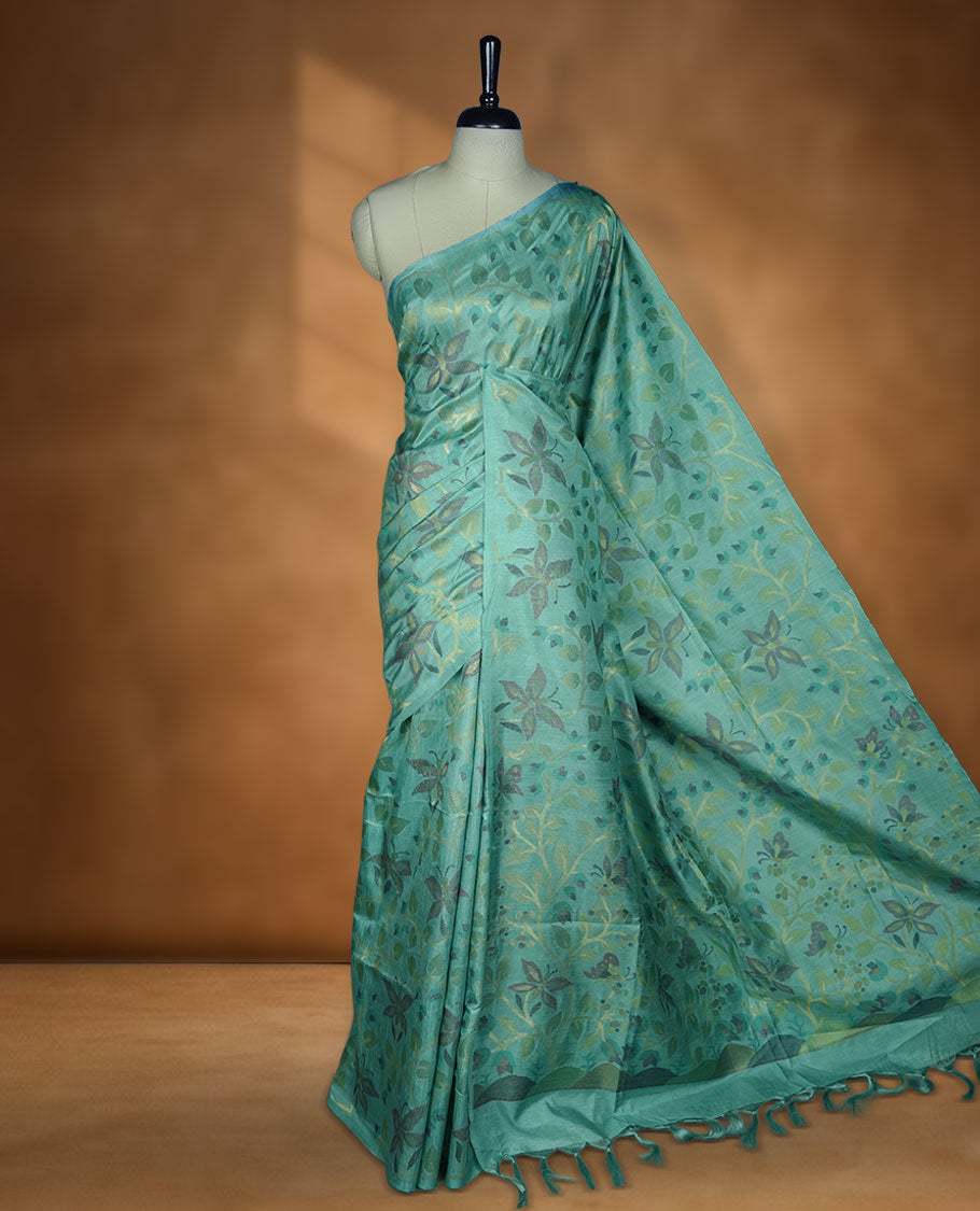 Mint colour semi tussar saree featuring woven Floral kodi & butterfly motifs on the body, complemented by a self colour without border pallu, paired with a matching blouse.