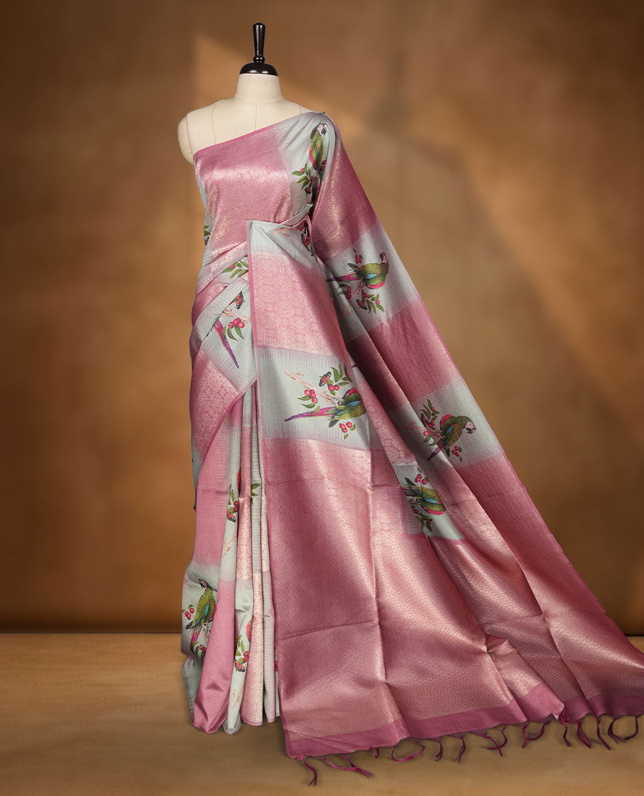 Dusty rose and silver colour semi tussar Banarasi saree featuring printed parrot and floral motifs, zari diamond buttas, a geometric gray-red zari border, and a matching blouse with woven accents.