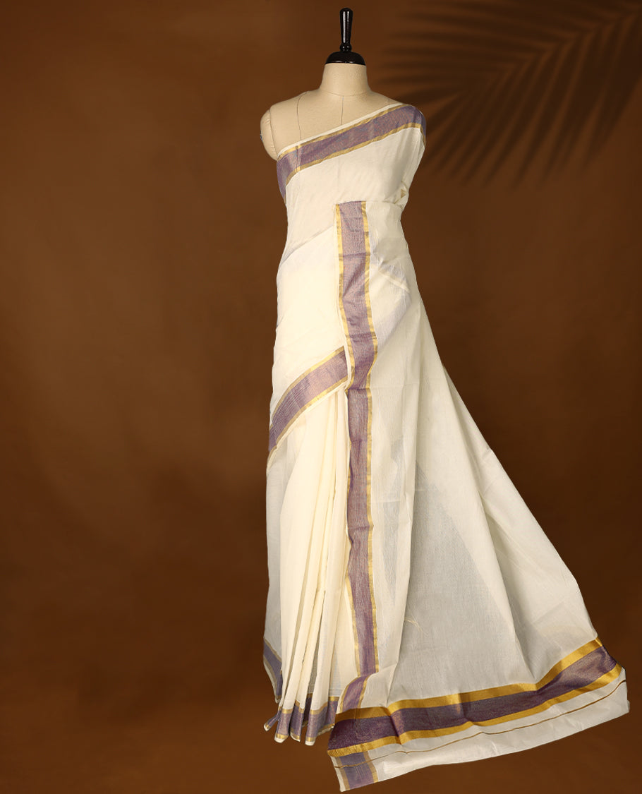 Elegant off white colour cotton Kerala saree featuring Plain body, Pastel purple & golden zari kasavu border offering a classic and graceful look, paired with a matching blouse.