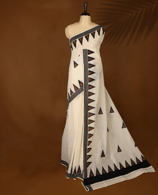 Elegant off white colour cotton Kerala saree featuring Plain body, Black colour border with brown colour temple designs, Paired with matching blouse offering a classic and graceful look