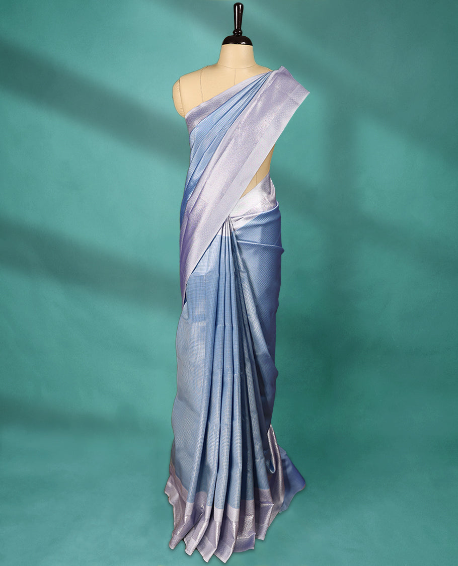 Light Blue coloured semi silk saree featuring a Check design on the body, paired with a Baby Blue coloured border and matching blouse.