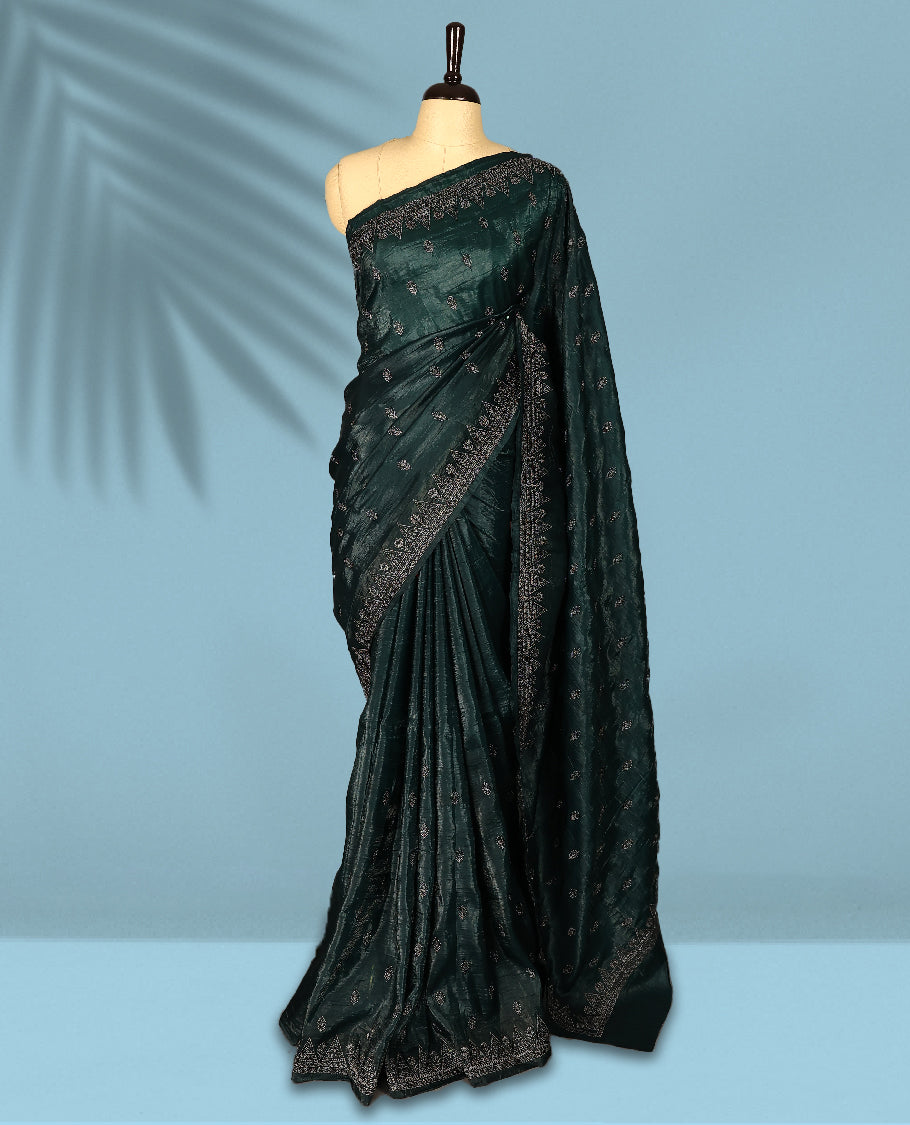 Deep Sea Green Colour crush soft silk saree, textured body with a natural crinkled finish, adorned with intricate Silver colored floral Motifs and complemented by a delicate Silver Zari embroidery border, paired with a matching blouse