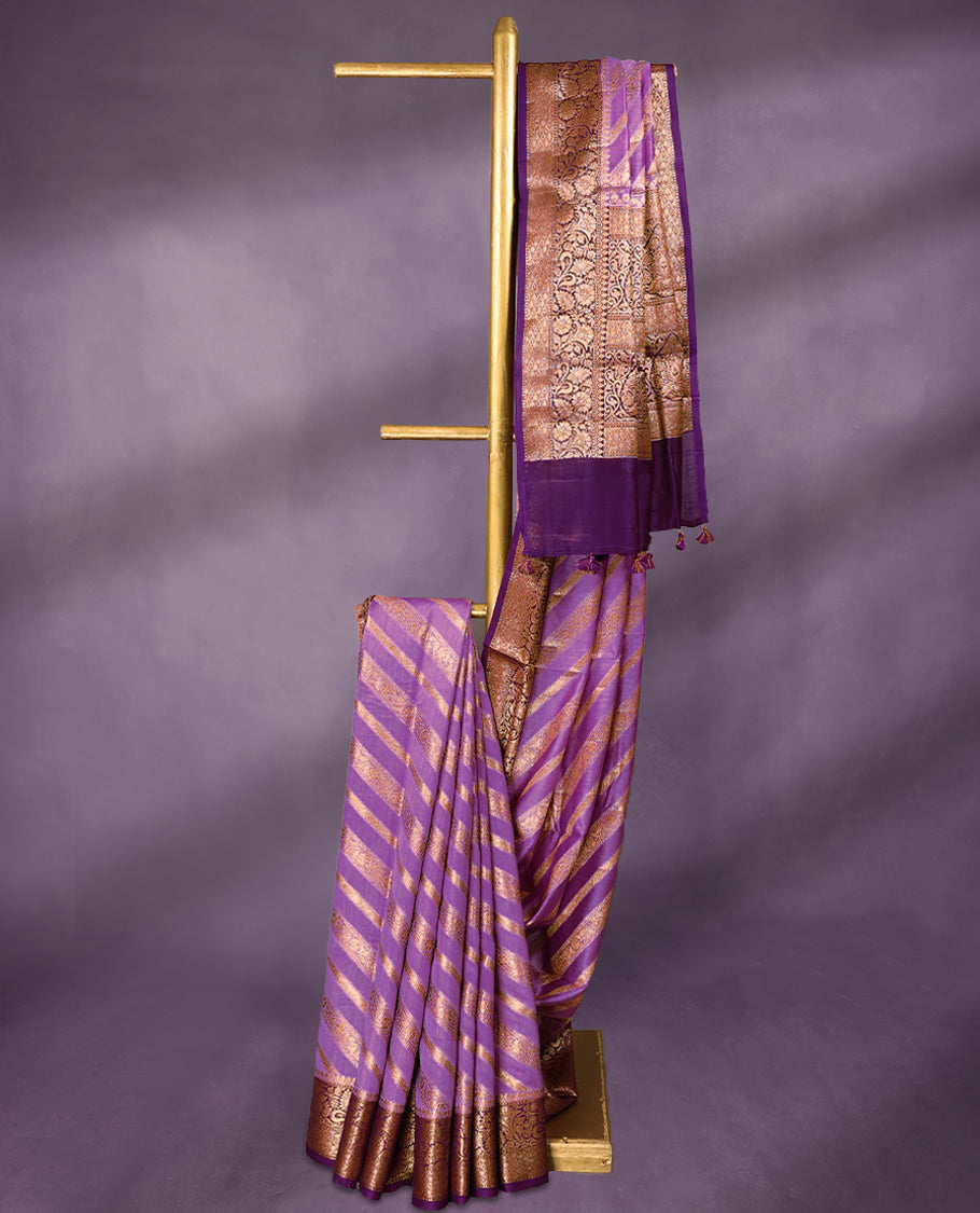 Lavender colour pure Banarasi Chanderi cotton, exquisitely detailed with traditional antique zari Aada designs across the body, finished with a hand-dyed contrast traditional border and a matching blouse.