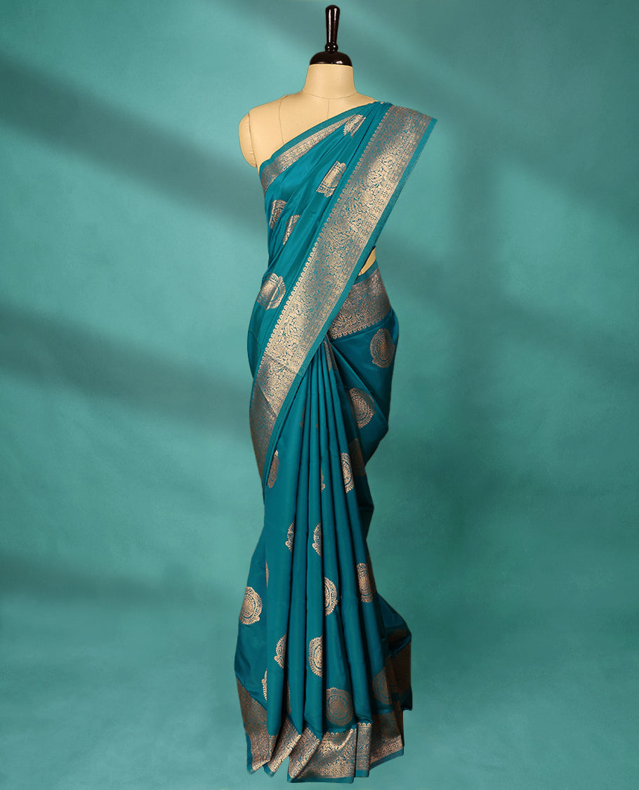 Blue coloured semi silk saree featuring a Golden Zari design on the body, paired with a Self coloured border and matching blouse.