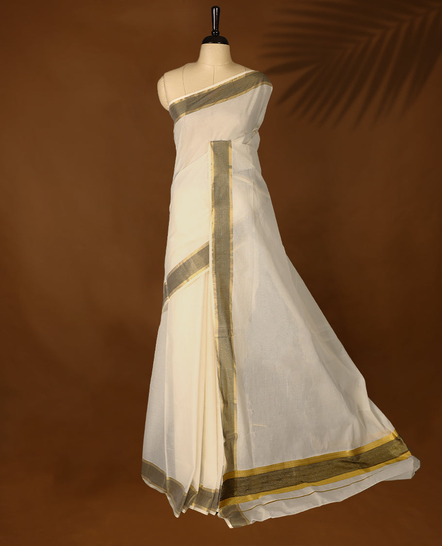 Elegant off white colour cotton Kerala saree featuring Plain body, Muted Black & golden zari kasavu border offering a classic and graceful look, paired with a matching blouse.