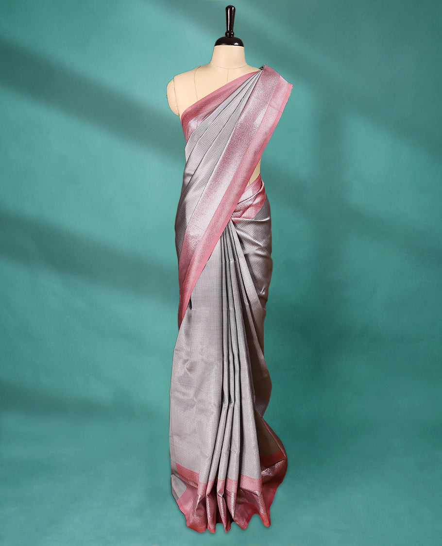 Silver coloured semi silk saree featuring a Self Coloured Check design on the body, paired with a Pastel Onion coloured border and matching blouse.