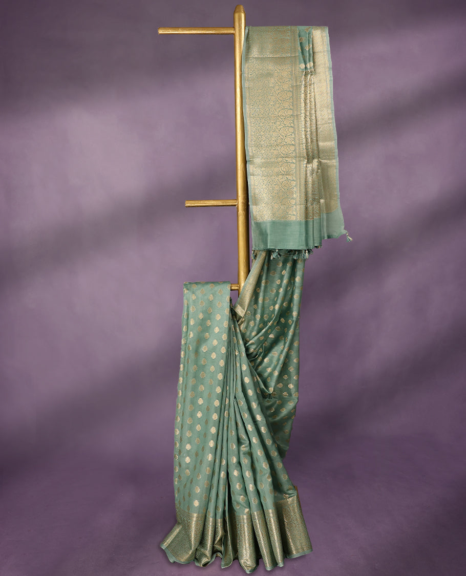 Light Aqua colour pure Banarasi Chanderi cotton, beautifully adorned with traditional antique zari Small Butta designs across the body, completed with a hand-dyed colour, a traditional border, and a matching blouse.