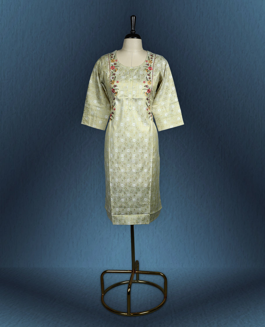 Pistachio green colour kurti with subtle floral self weave, adorned with delicate multicolour floral embroidery along the princess line, featuring a round neckline and stylish three quarter sleeves.