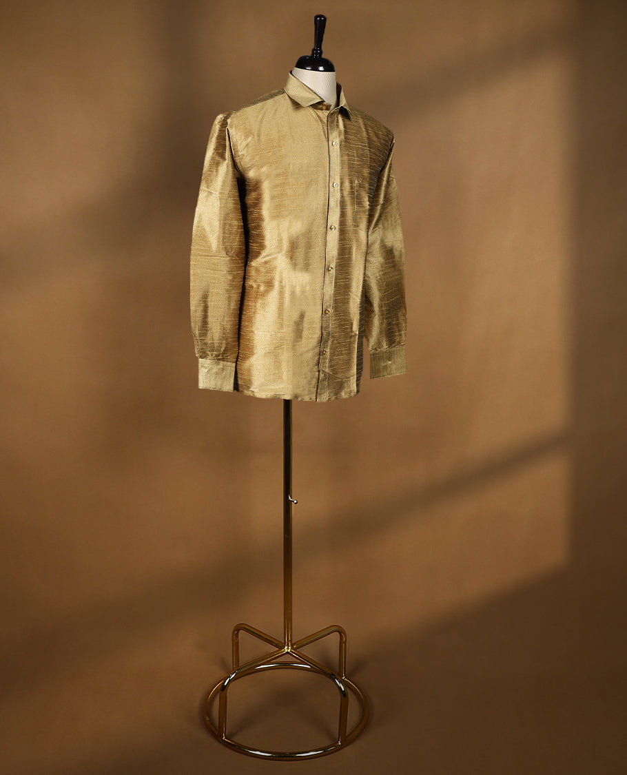 Antique Gold colour DH men’s shirt crafted in a lustrous semi silk textured fabric featuring a sleek finish, classic collar, full sleeves, and chest pocket perfect for weddings and festive occasions