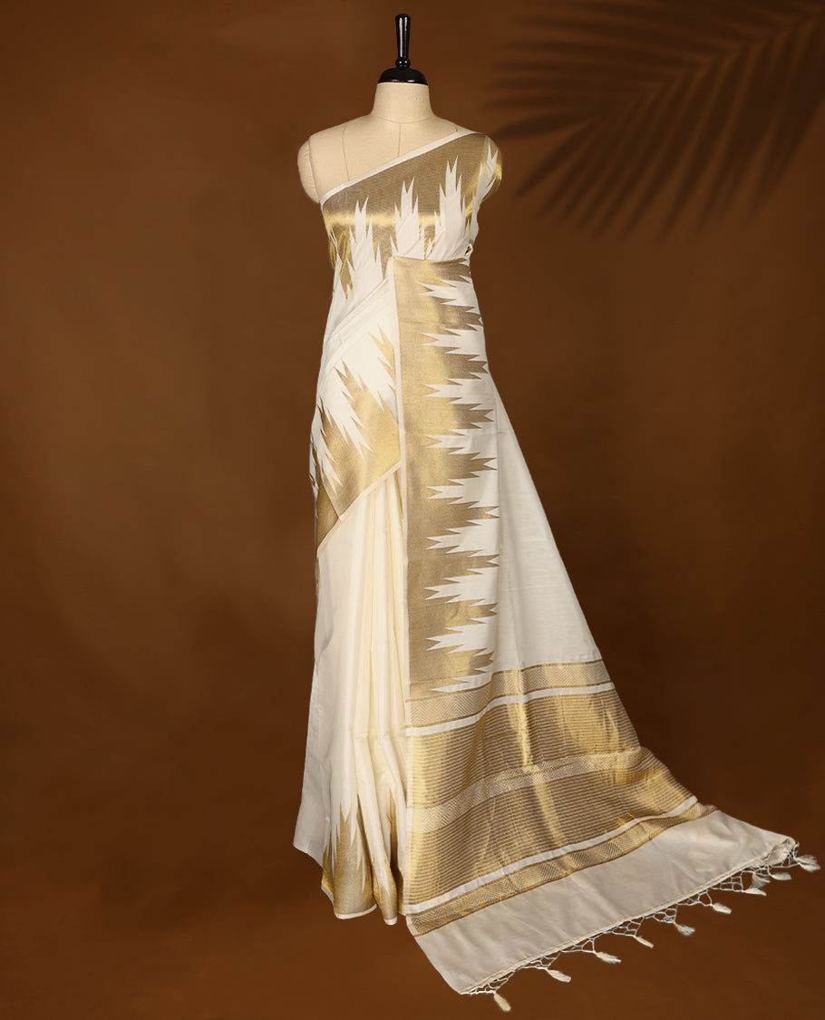 Elegant white colour sotf Tussar Kerala saree featuring Plain body, Gold kasavu Rich Temple border, Paired with matching blouse offering a classic and graceful look