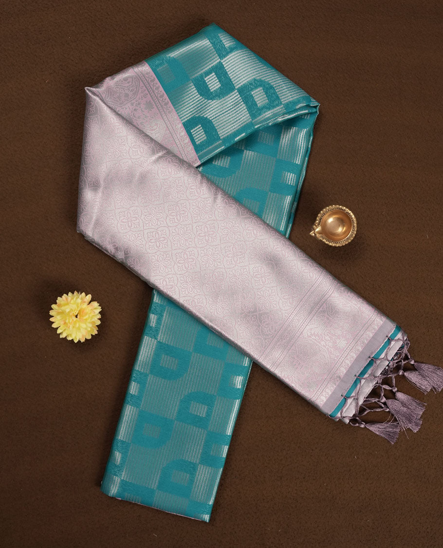 Teal Green colour Semi Silk Saree with Self-Checked Geometric Patterns on the Body, Contrasting Ice Silver Zari Woven Pallu and Border Featuring Intricate Paisley-Floral Motifs and Tassels, Paired with Coordinated Blouse Piece