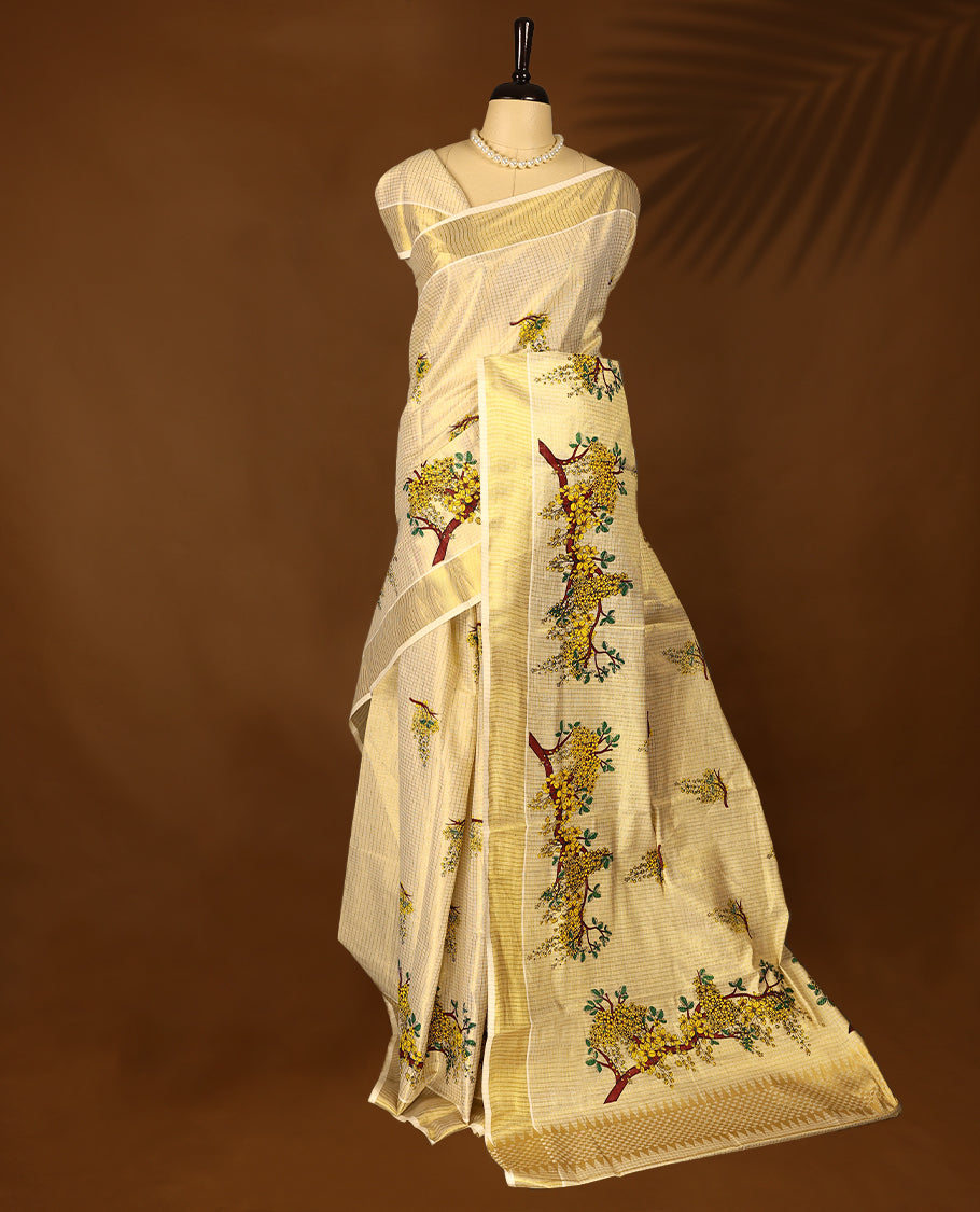 Golden Kerala Tissue saree adorned with vibrant tree-floral motifs and subtle golden border with Matching Blouse