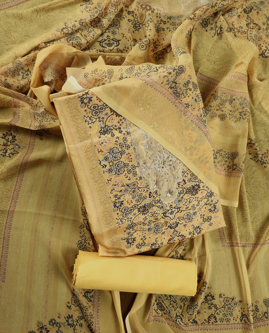 Pastel yellow colour churidhar material with intricate floral prints, sequin embroidery on the top, plain matching bottom, and a coordinated dupatta.