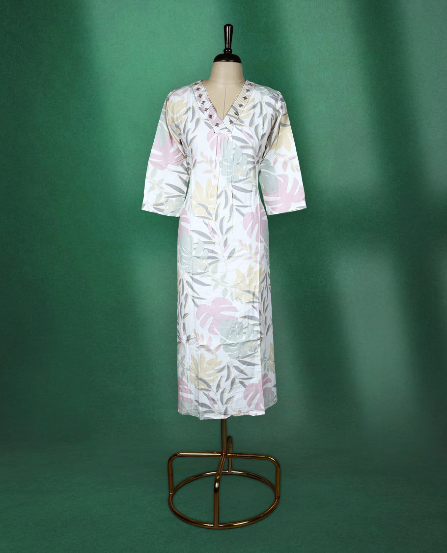 White colour kurti featuring pastel botanical prints in shades of pink, mint, and beige, designed with a V neckline embellished with delicate embroidery and finished with three quarter sleeves & soft, airy choice for effortless everyday wea