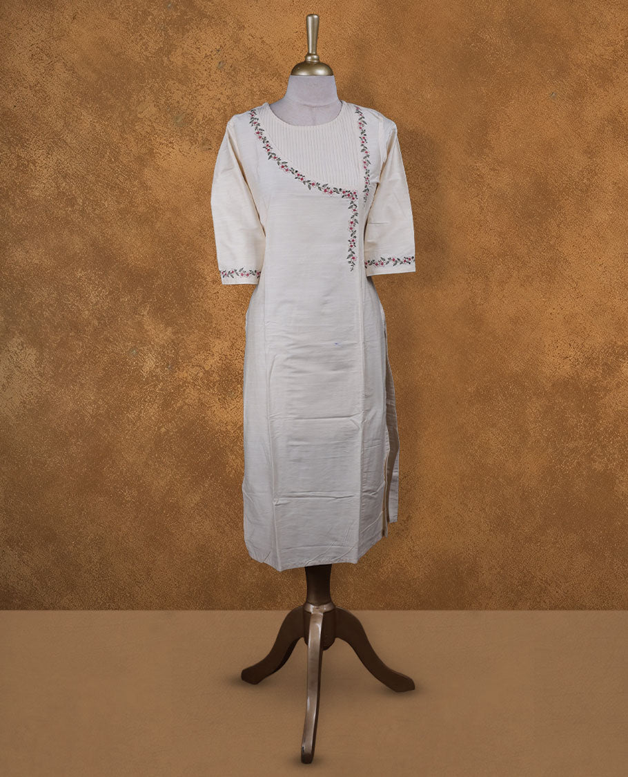 Cream colour kurti with multicolour floral thread pattern, knee length design, styled with a round neckline and a sleeve .