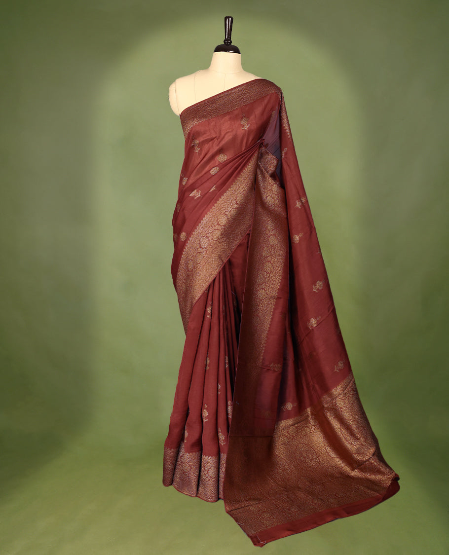 Rust Orange semi-Banaras tussar georgette saree embellished with antique zari motifs across the body, complemented by a rich heritage Banaras border and paired with a matching blouse.