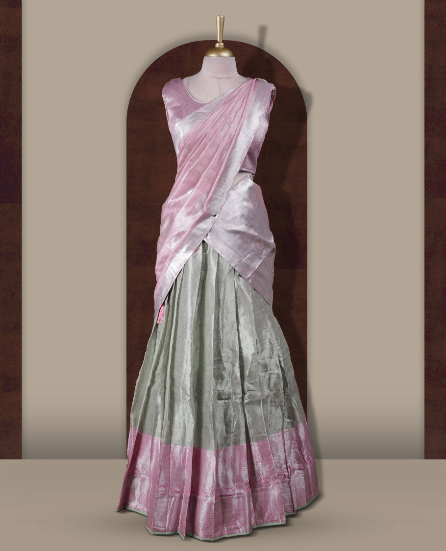 Light green and pink colour Dhavani set featuring a Light green colour skirt with contrast Pink colour border with rich silver zari pattern, paired with a contrasting Pink dupatta detailed with silver motifs