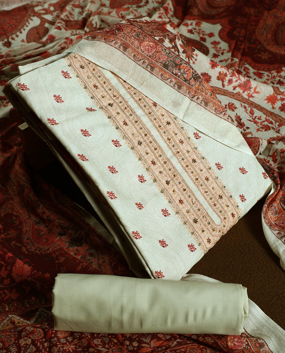 Beige colour churidhar material adorned with delicate floral embroidery and sequin accents, paired with a plain matching bottom and a richly printed dupatta in maroon and rust tones for a graceful ethnic look.