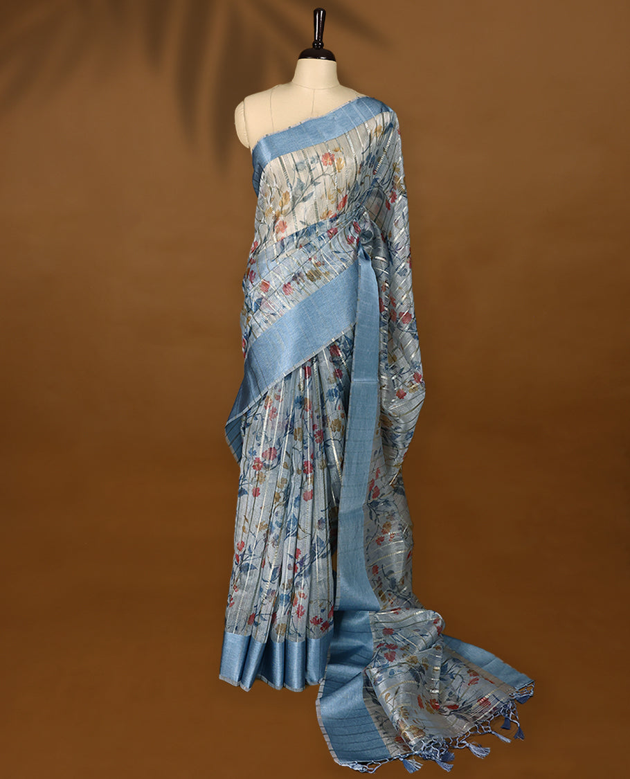 Blue semi-organza saree with intricate floral jaal work, elegant border, and a matching silk brocade blouse.