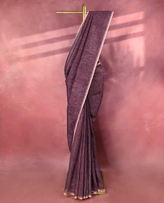 Grape wine colour pure linen saree featuring fine beige thread stripes running throughout the body, accented with a soft beige border and pairs gracefully with a matching blouse.