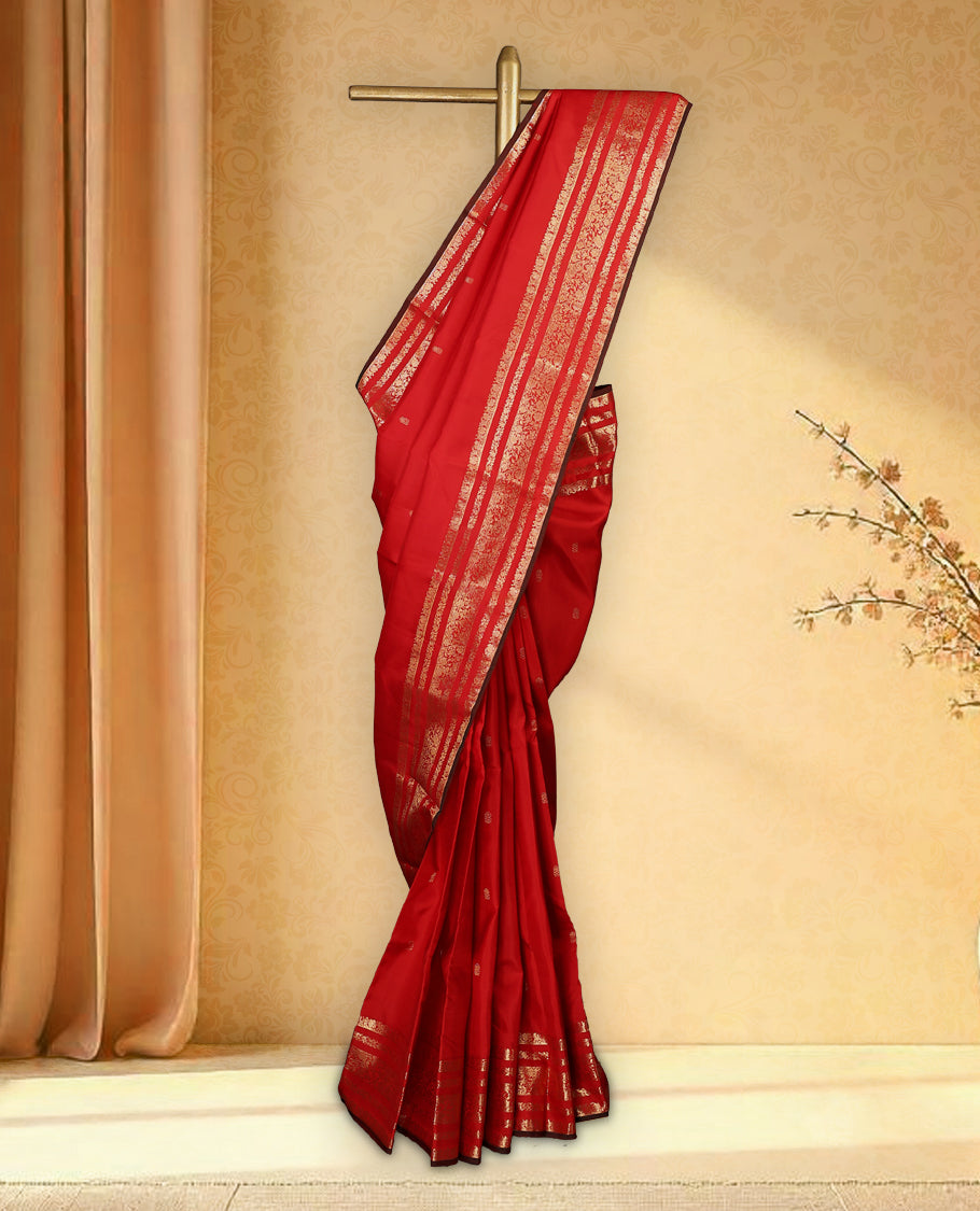 Deep red colour pure Kancheepuram saree with gold zari small floral motifs on the body, traditional border with floral kodi motifs and dark piping grand gold zari woven pallu, paired with contrast matching blouse