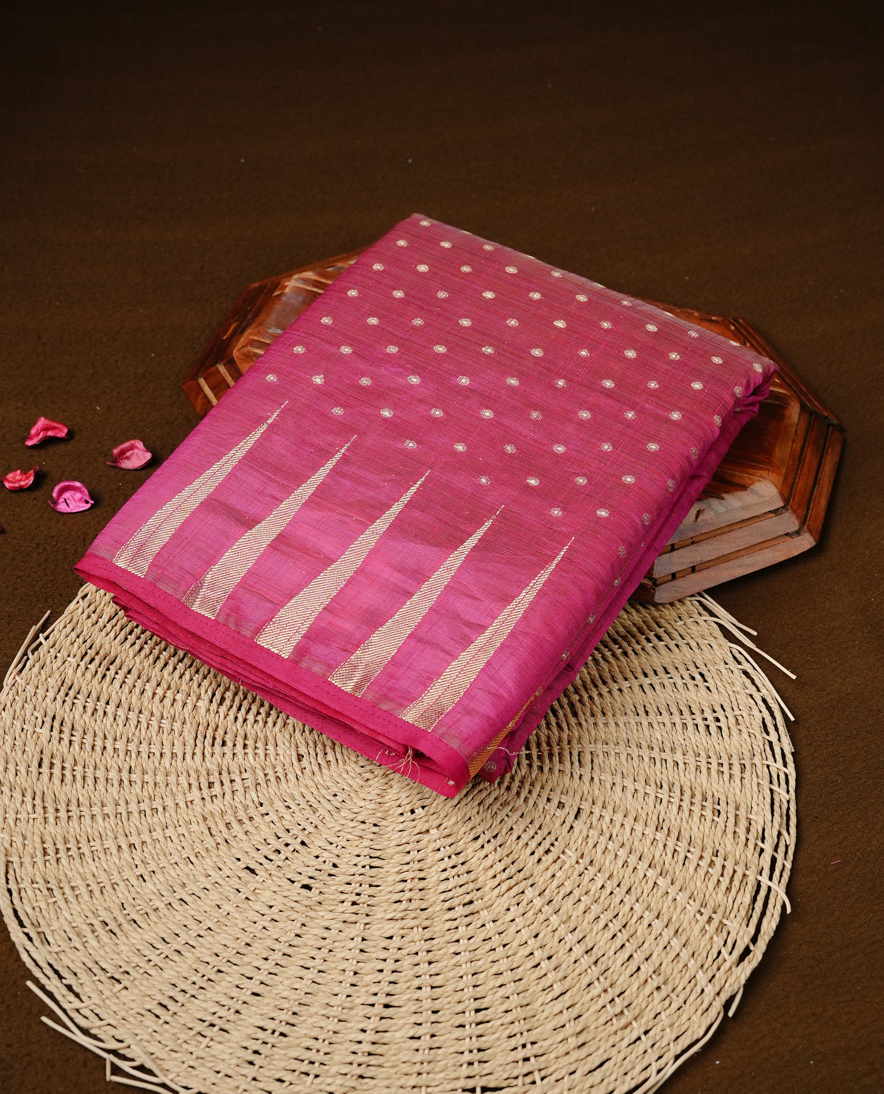 Rani pink colour semi tussar silk saree featuring gold zari dot motifs all over the body, highlighted by a self colour border with intricate gold zari temple patterns. Comes paired with a matching blouse piece.