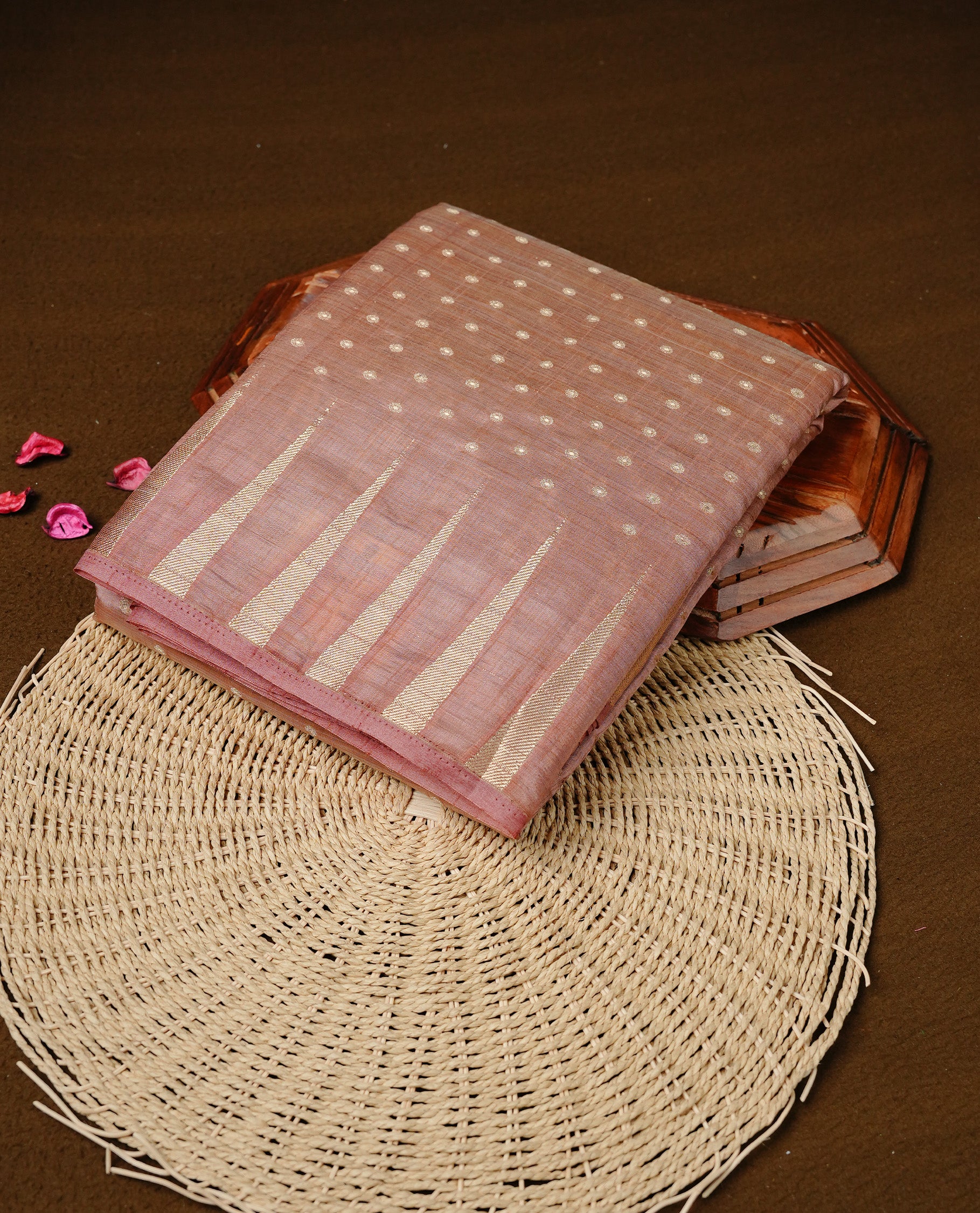 Dusty Rose colour semi tussar silk saree featuring gold zari dot motifs all over the body, highlighted by a self colour border with intricate gold zari temple patterns. Comes paired with a matching blouse piece.
