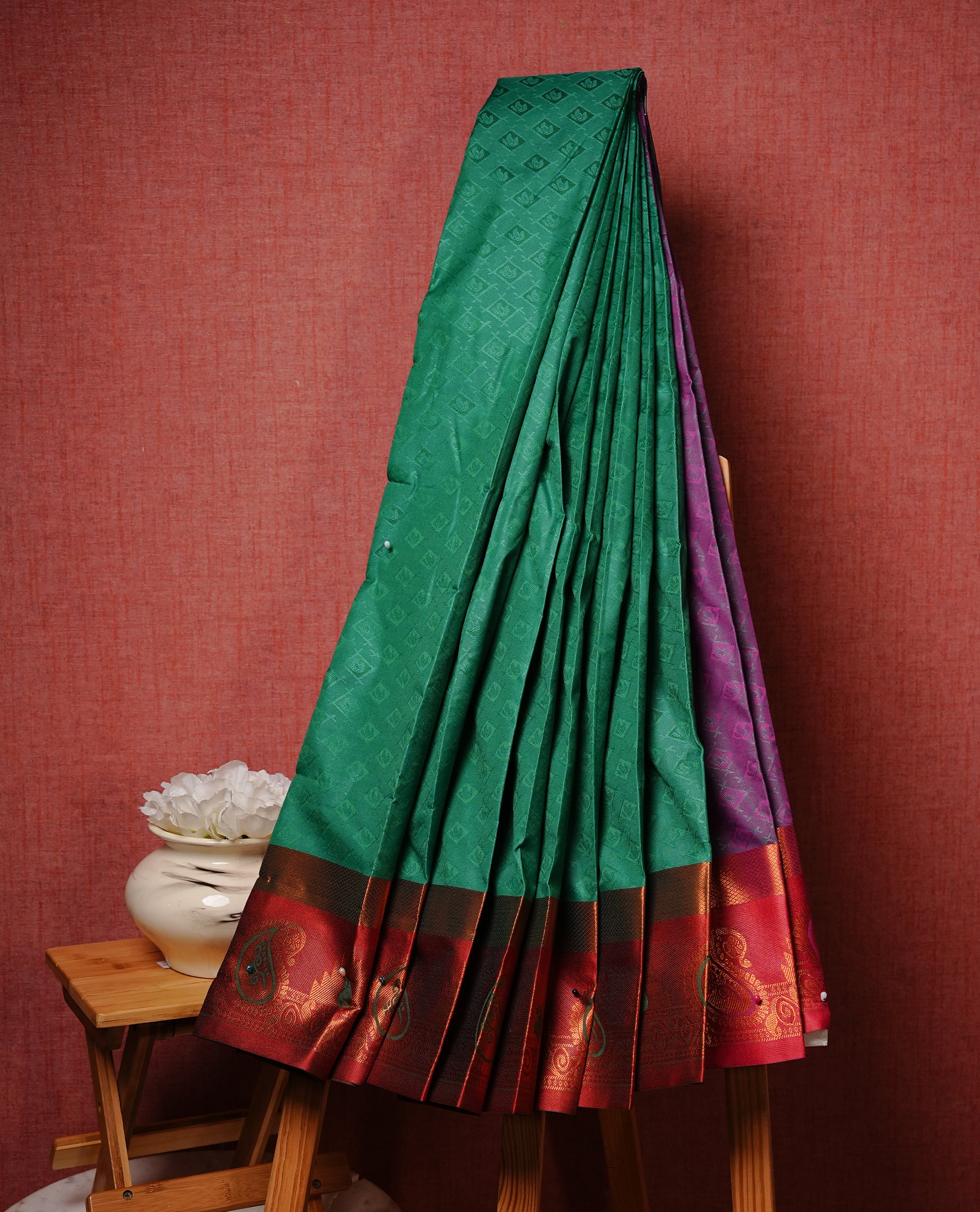 Grass green colour Semi silk saree Featuring self colour zari motifs on body, complemented by contrast Brick red colour with gold zari border, paired with matching blouse piece.