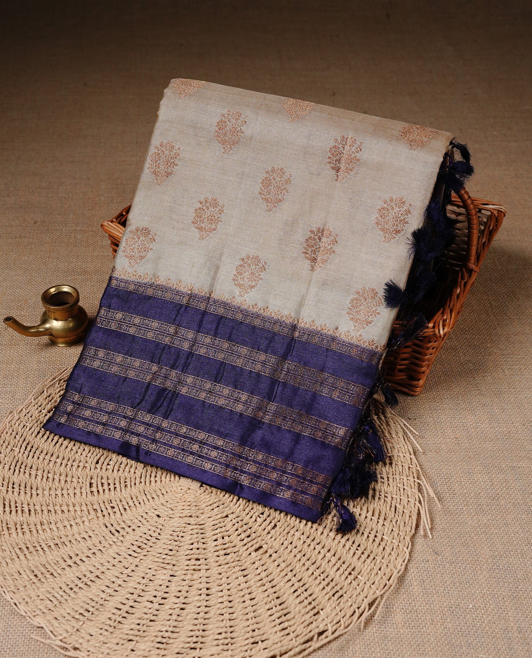 Golden Cream Colour Banaras tussar silk saree featuring Antique zari Motifs on body, Complemented by Violet colour variant with zari border, paired with matching blouse Piece.