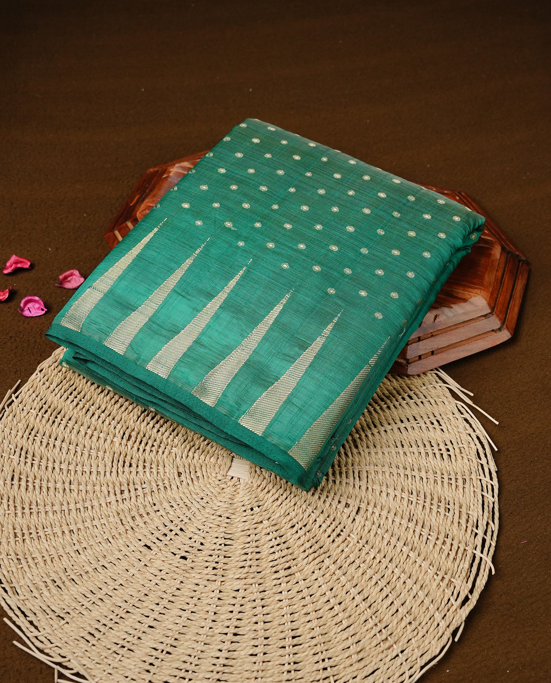 Cadmium green colour semi tussar silk saree featuring gold zari dot motifs all over the body, highlighted by a self colour border with intricate gold zari temple patterns. Comes paired with a matching blouse piece.