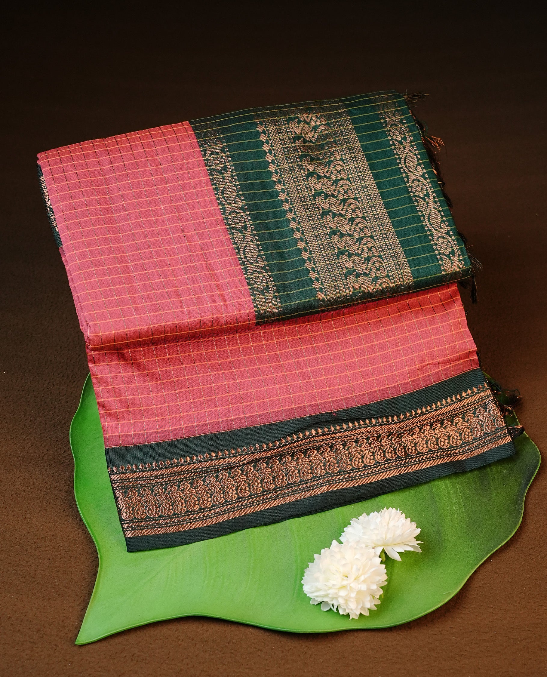 Pinkish peach colour kalyani cotton saree featuring gold zari check pattern on body, complemented by green colour with Antique zari border, paired with matching blouse piece.