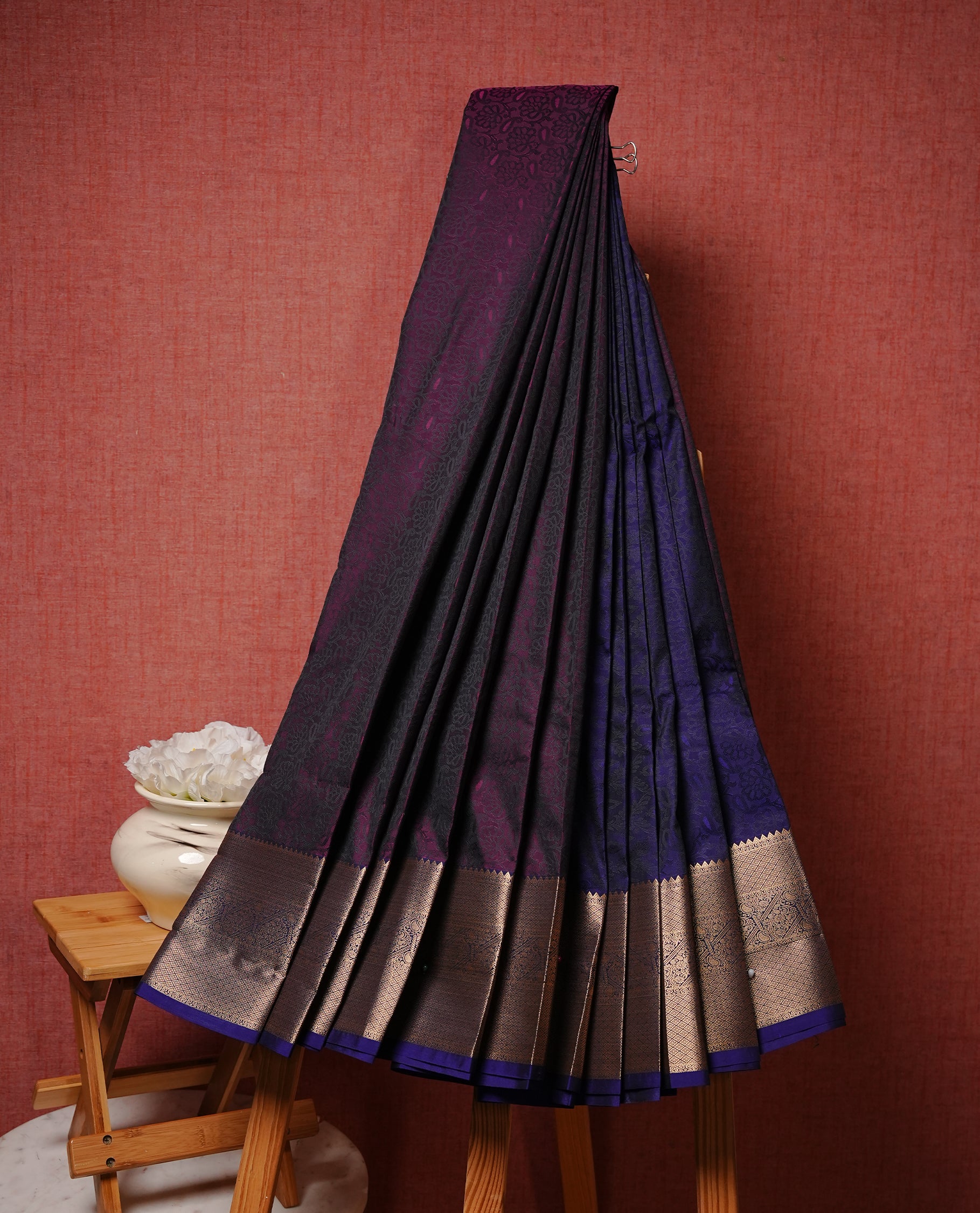 Purple pink colour Semi silk saree Featuring black colour patterns on body, complemented by contrast blue colour with gold zari border, paired with matching blouse piece.