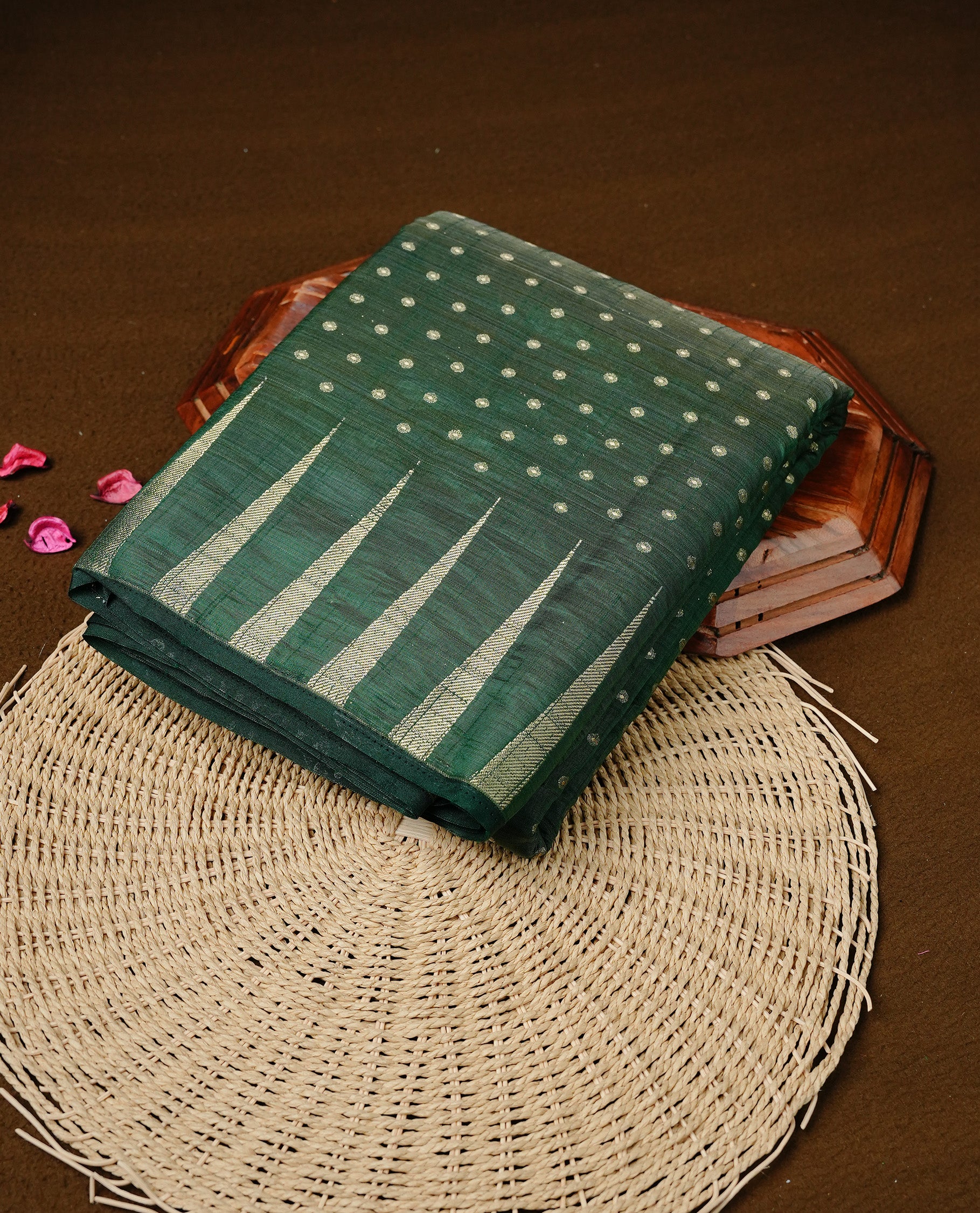 Green colour semi tussar silk saree featuring gold zari dot motifs all over the body, highlighted by a self colour border with intricate gold zari temple patterns. Comes paired with a matching blouse piece.